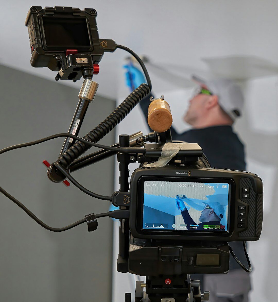 Camera operator filming with a professional broadcast video camera
