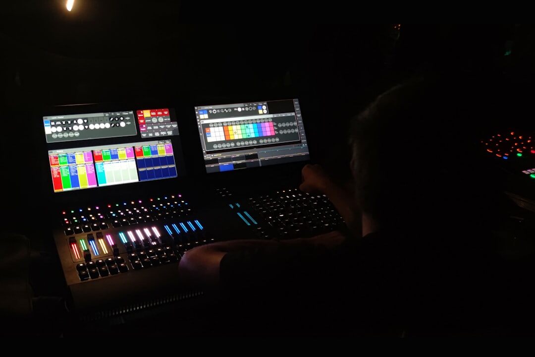 Video editor working at a multi monitor editing workstation