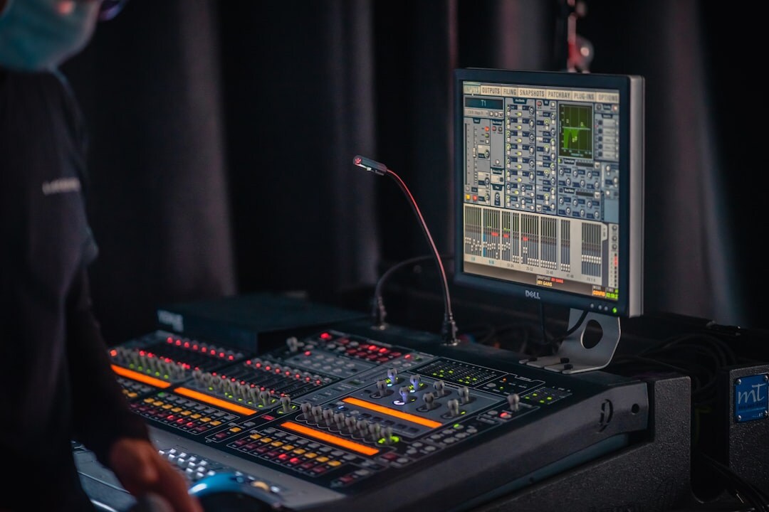Broadcast control room with multiple live monitors and mixing console